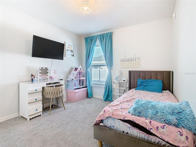 bedroom featuring carpet and baseboards