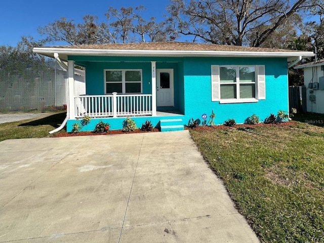 bungalow featuring a porch and a front lawn