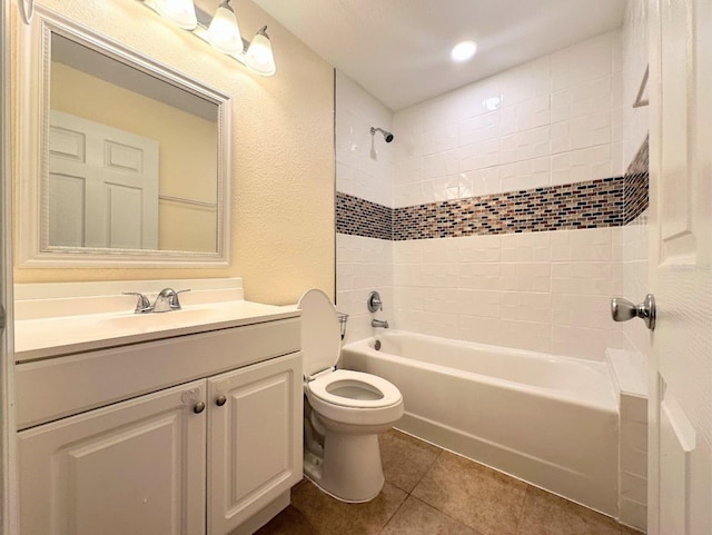 full bathroom with vanity, tile patterned floors, toilet, and tiled shower / bath