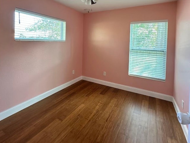 unfurnished room featuring ceiling fan and dark hardwood / wood-style flooring