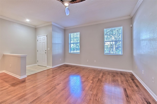 foyer with crown molding, wood-type flooring, and a textured ceiling