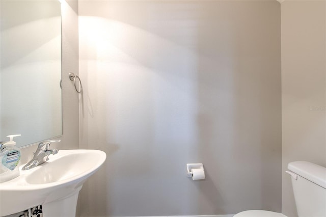 bathroom featuring sink and toilet