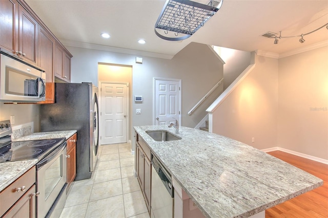 kitchen with sink, a kitchen island with sink, light stone counters, stainless steel appliances, and crown molding