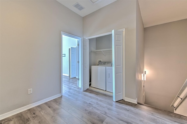 washroom featuring separate washer and dryer and light hardwood / wood-style flooring