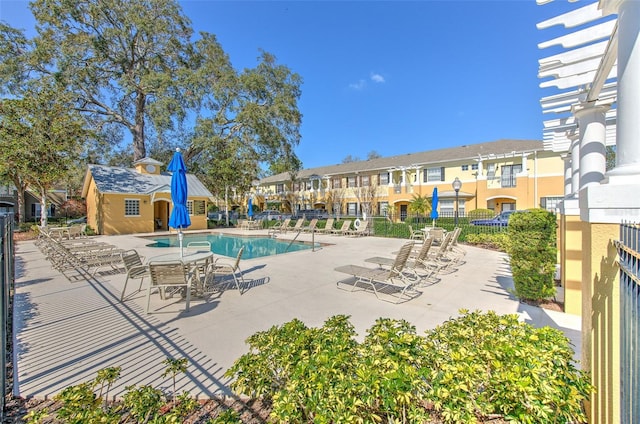 view of pool with an outbuilding and a patio area