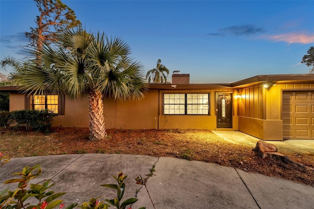 view of front of house featuring a garage and stucco siding