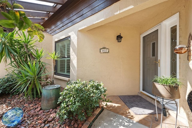 doorway to property featuring a pergola