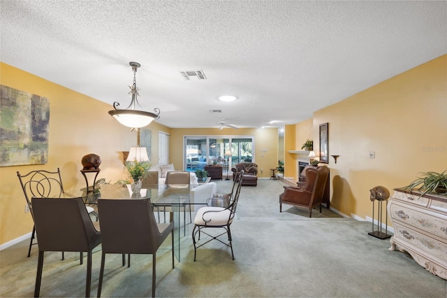 carpeted dining space featuring a textured ceiling