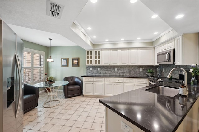 kitchen featuring pendant lighting, white cabinets, and appliances with stainless steel finishes