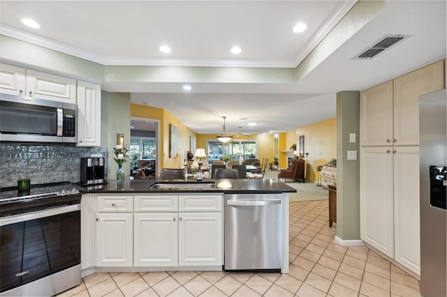 kitchen featuring sink, appliances with stainless steel finishes, backsplash, ornamental molding, and light tile patterned flooring