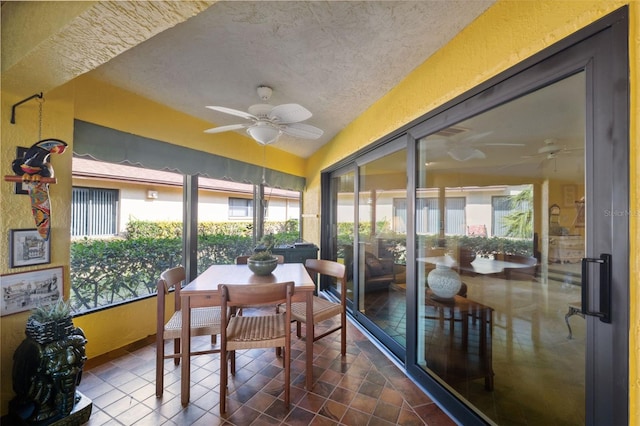 sunroom featuring vaulted ceiling and ceiling fan