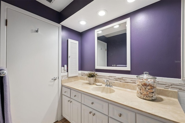 bathroom with vanity and backsplash