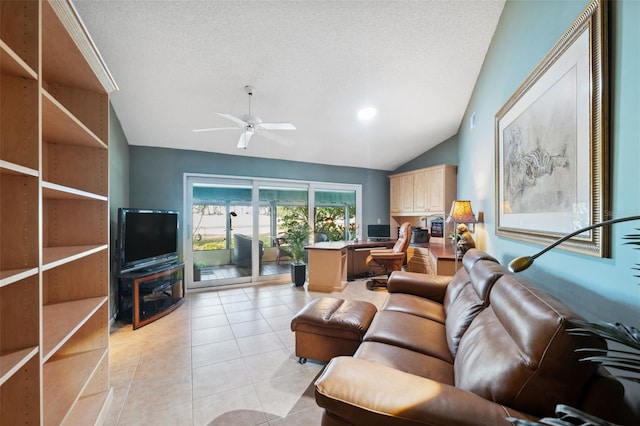 living room featuring ceiling fan, vaulted ceiling, a textured ceiling, and light tile patterned floors