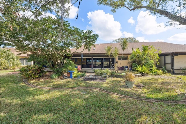 rear view of property with a lawn