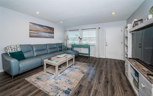 living room featuring dark hardwood / wood-style floors and a textured ceiling