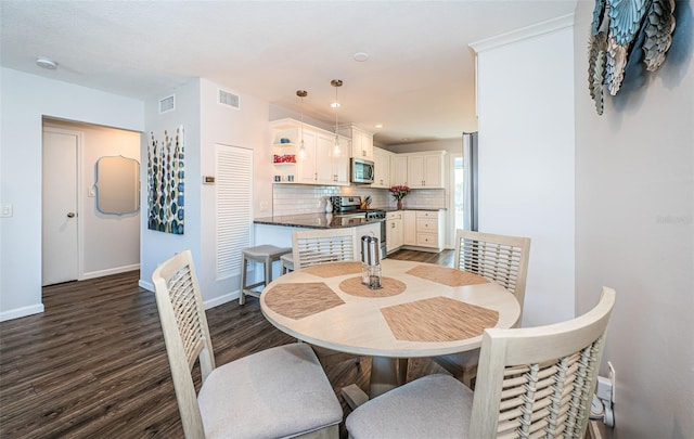 dining area with dark hardwood / wood-style flooring