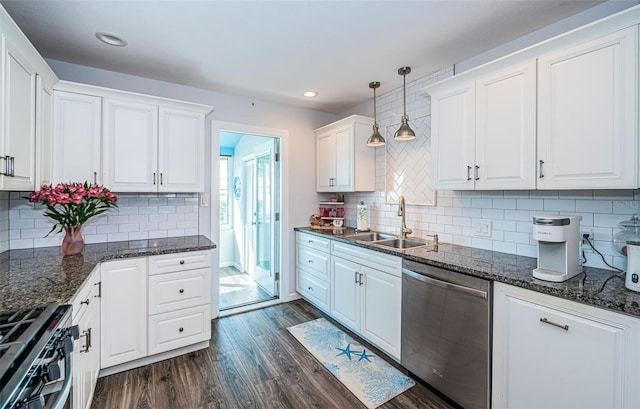 kitchen with sink, white cabinetry, hanging light fixtures, appliances with stainless steel finishes, and dark hardwood / wood-style flooring