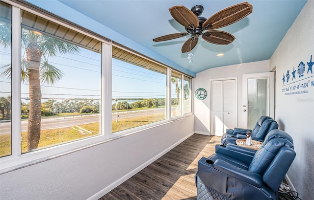 sunroom featuring ceiling fan and vaulted ceiling