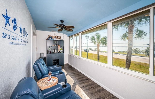 sunroom / solarium featuring ceiling fan