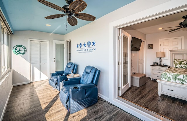 living area featuring dark hardwood / wood-style flooring and ceiling fan