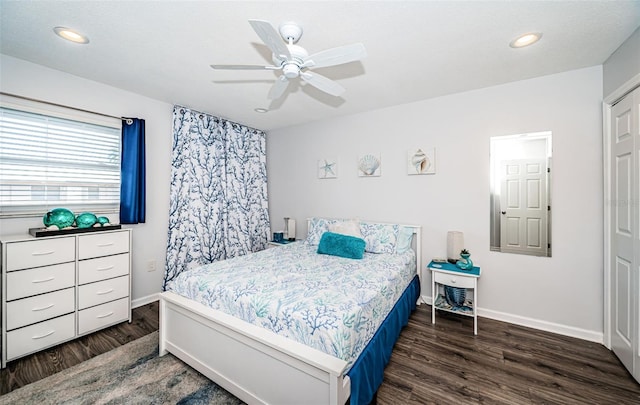 bedroom featuring dark wood-type flooring, ceiling fan, and a closet