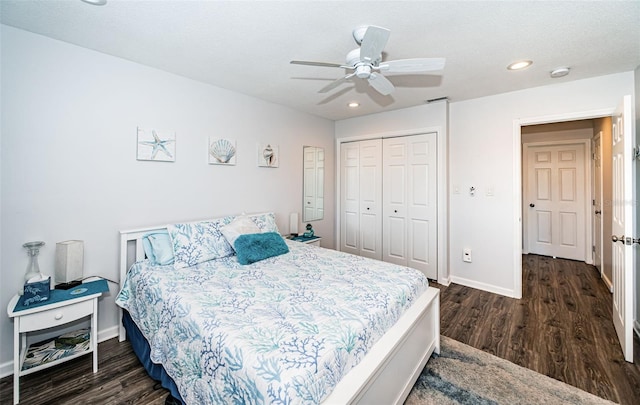 bedroom with ceiling fan, dark hardwood / wood-style flooring, a closet, and a textured ceiling