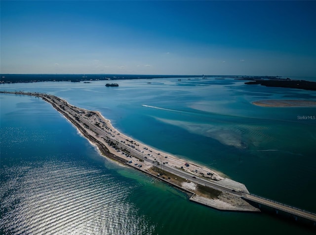 drone / aerial view with a water view and a beach view