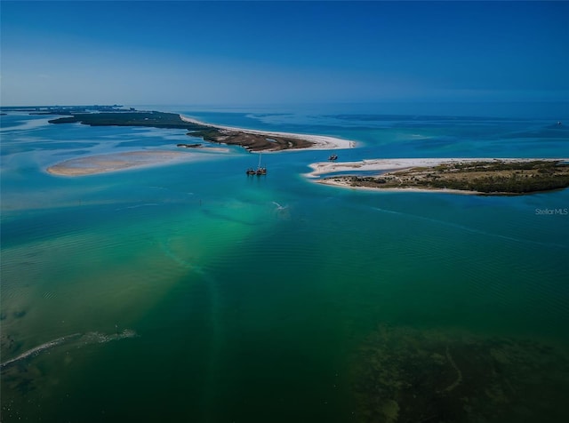 bird's eye view with a water view and a beach view