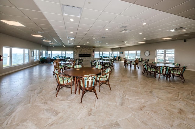 dining space featuring a paneled ceiling and a wealth of natural light