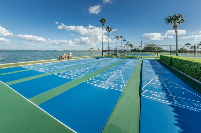 surrounding community featuring a water view and tennis court