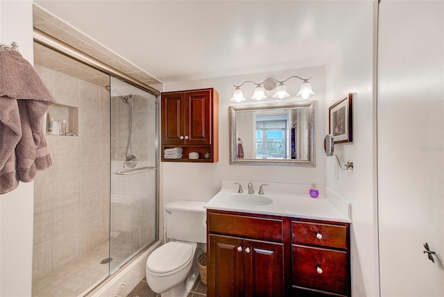 bathroom with vanity, toilet, and a shower with shower door