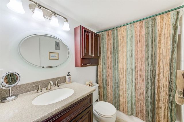 bathroom with a shower with curtain, vanity, and toilet