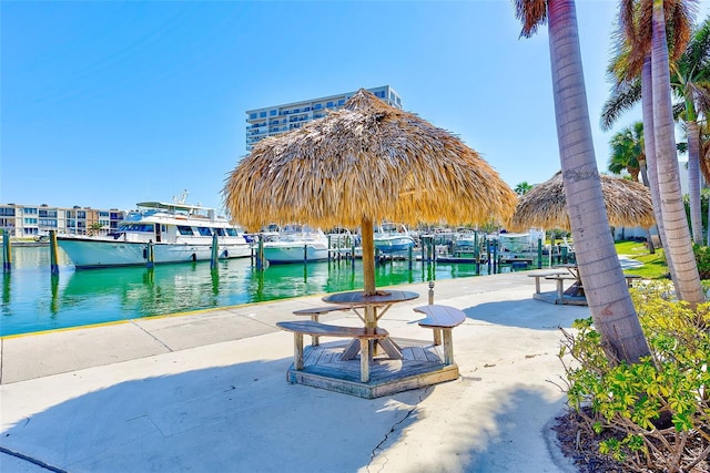 view of home's community featuring a water view and a boat dock