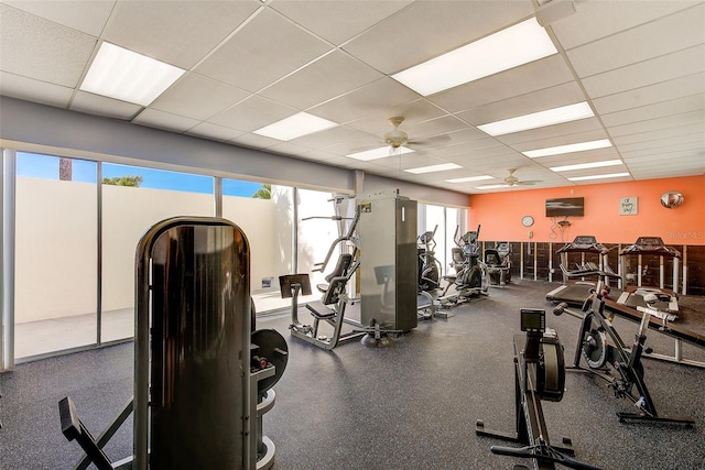 exercise room featuring a paneled ceiling and ceiling fan