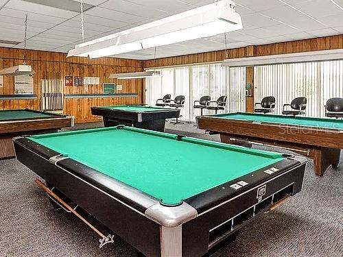 playroom featuring billiards and wood walls