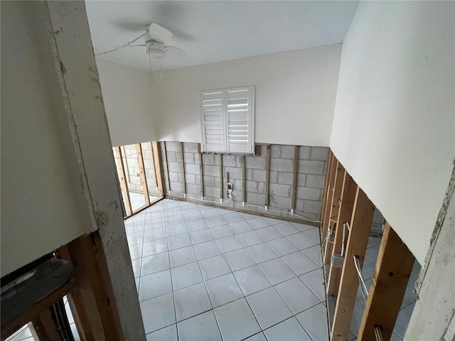 tiled spare room featuring ceiling fan