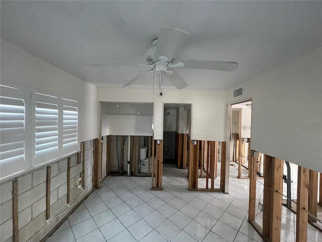 unfurnished room with ceiling fan and light tile patterned floors