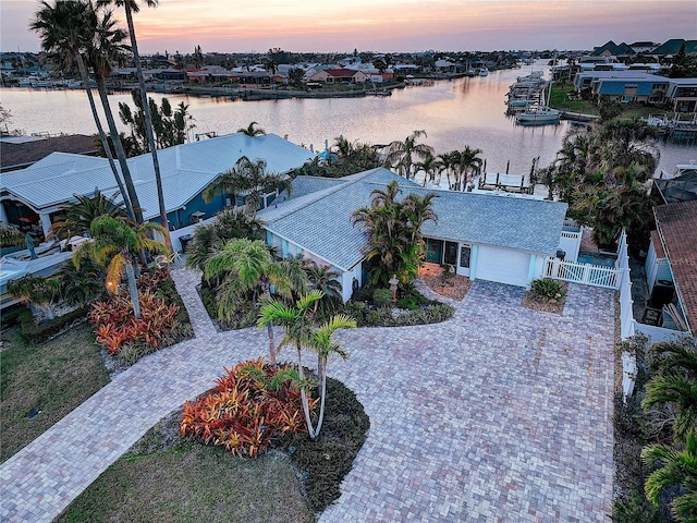 aerial view at dusk with a water view