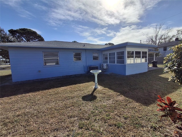 view of property exterior with a yard and a sunroom