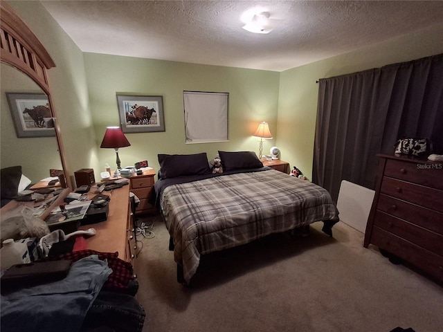 bedroom featuring carpet floors and a textured ceiling