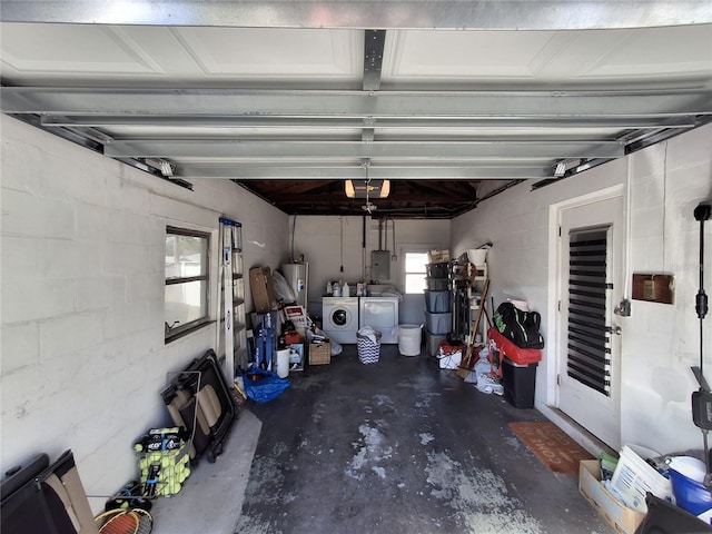 garage with water heater, washing machine and dryer, a garage door opener, and electric panel