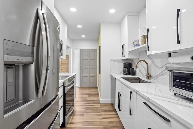 1200 N Shore Dr NE Unit 204, Saint Petersburg, FL 33701 - kitchen featuring white cabinets, stainless steel appliances, and a sink