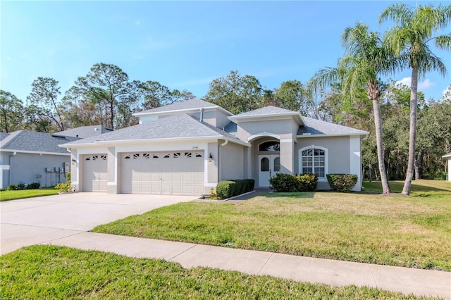 view of front of house with a garage and a front yard