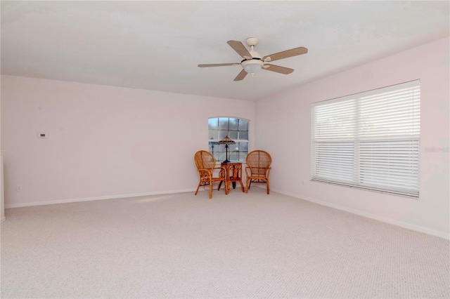 sitting room with light carpet and ceiling fan