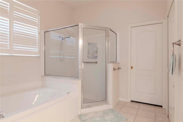 bathroom featuring tile patterned flooring and separate shower and tub