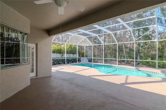 view of swimming pool featuring a patio, a lanai, and ceiling fan