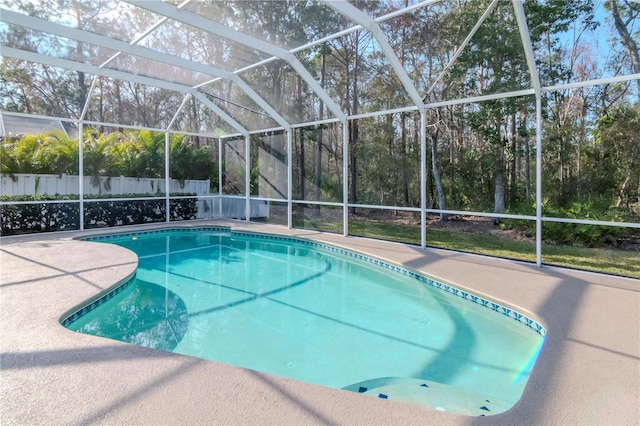 view of swimming pool with a lanai and a patio