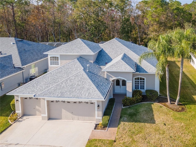 view of front of house with a garage and a front lawn