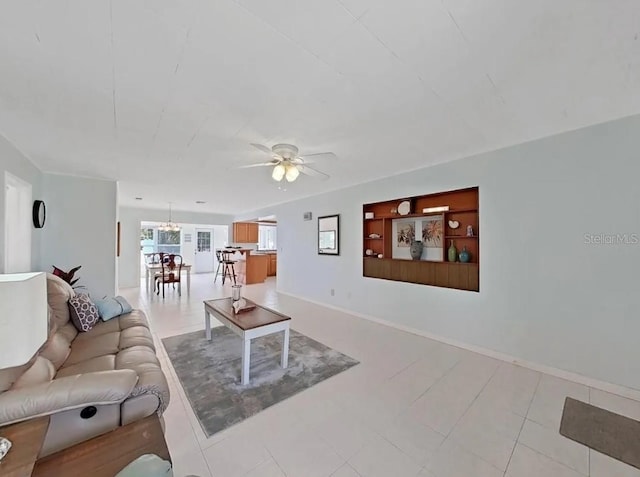 living room featuring built in features and ceiling fan