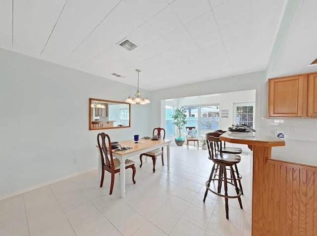 dining space featuring an inviting chandelier and light tile patterned floors